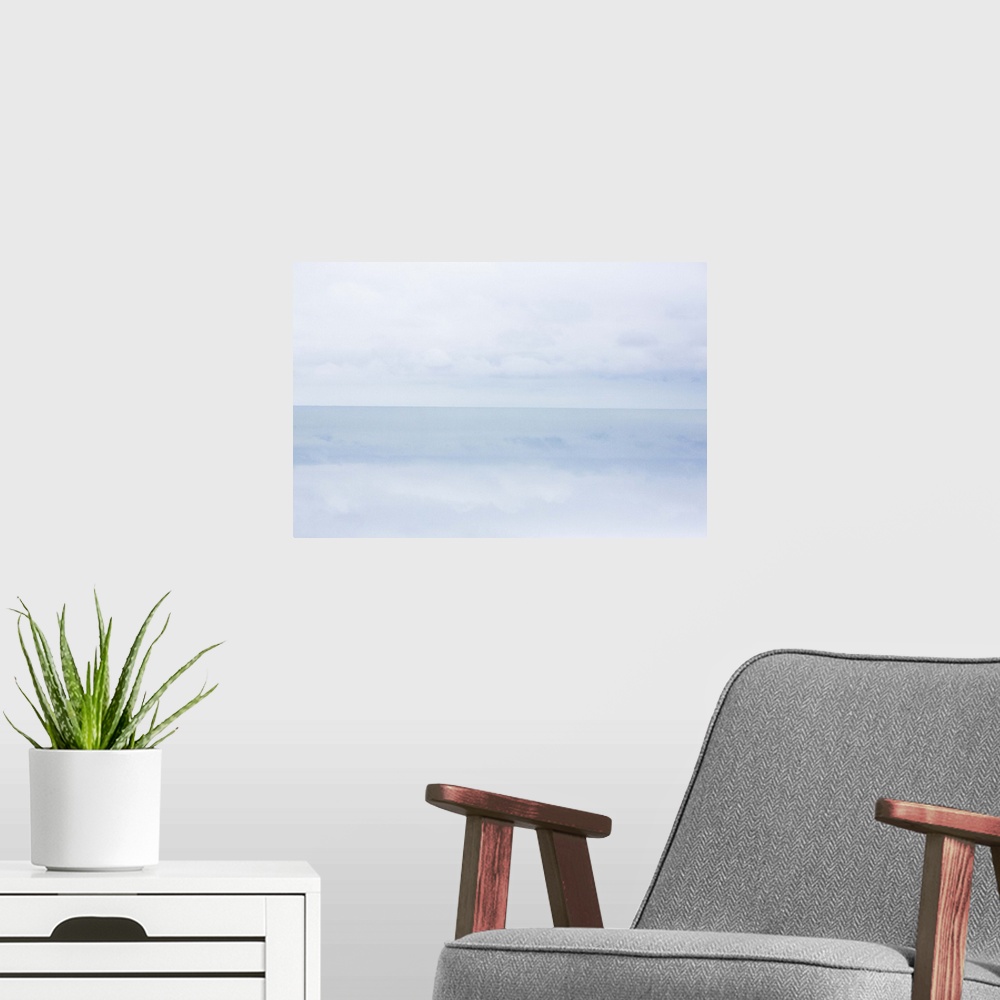 A modern room featuring A photograph of a cold and frigid seascape.
