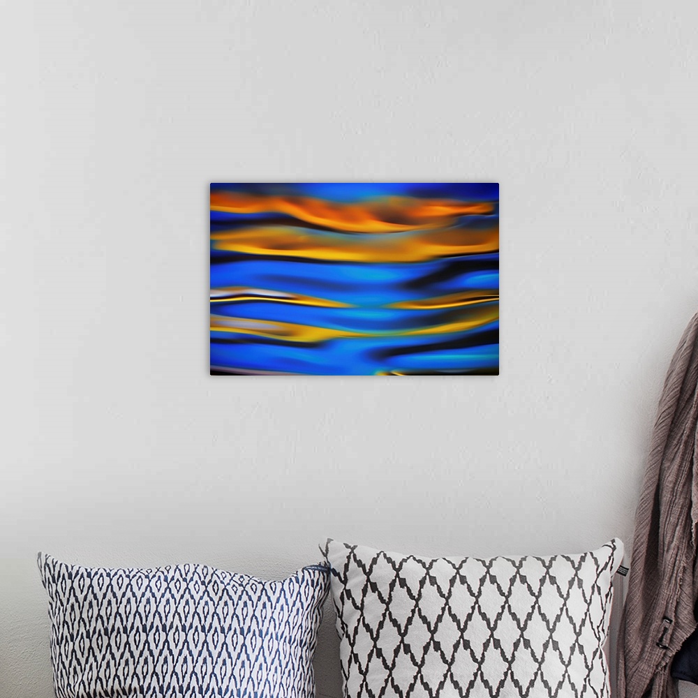 A bohemian room featuring Surreal landscape with waves of reflecting color in yellow, blue, and black.