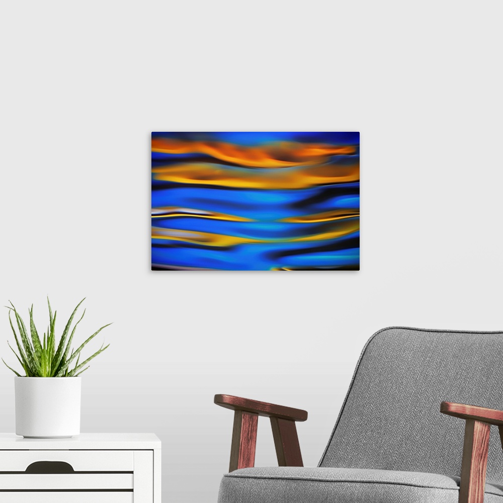 A modern room featuring Surreal landscape with waves of reflecting color in yellow, blue, and black.