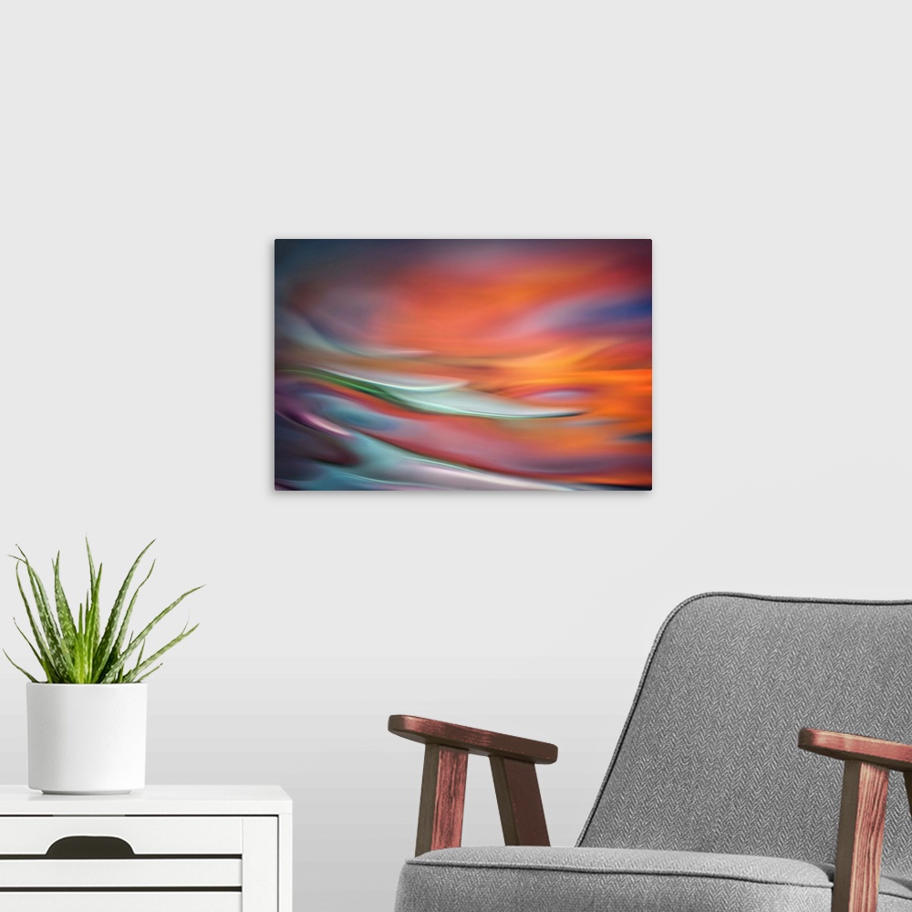 A modern room featuring Abstract photo of smooth waves in warm, fiery tones.