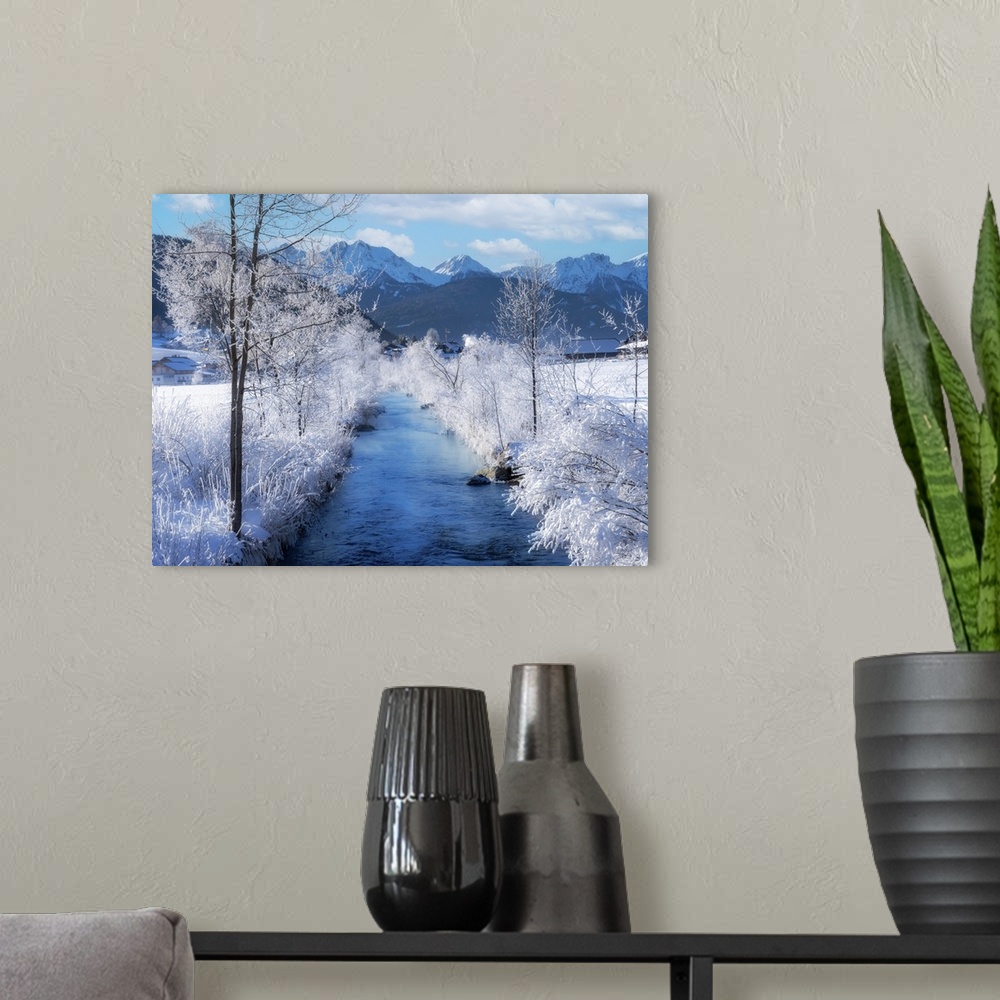 A modern room featuring I stopped to take a picture of this blue mountain river passing between completely snow-covered w...