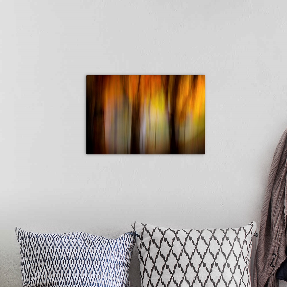 A bohemian room featuring Abstract photograph of an autumn scene in warm, glowing tones, reminiscent of a forest at sunset.