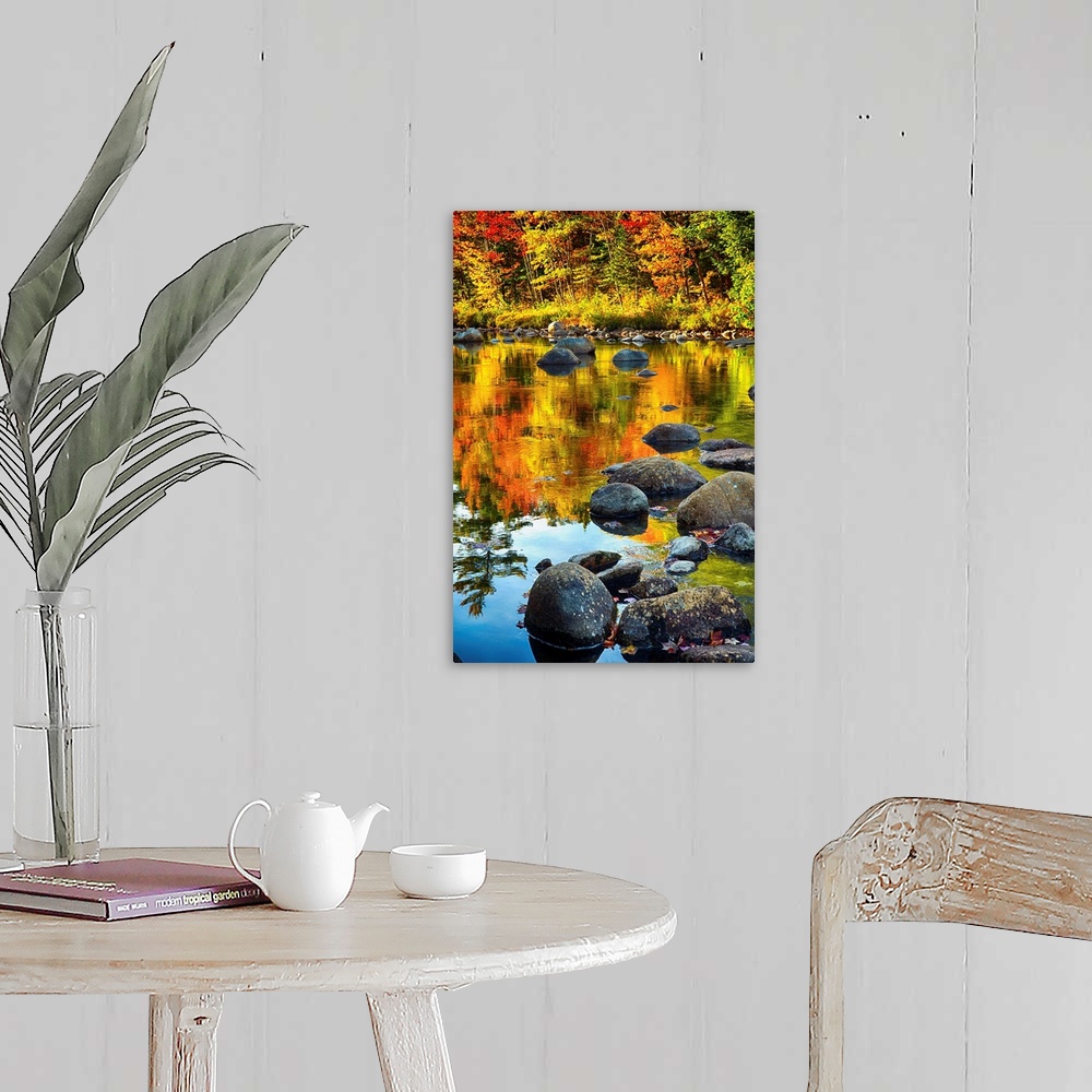 A farmhouse room featuring Fine art photo of bright colors of a forest in autumn being reflected in a pond full of rocks.