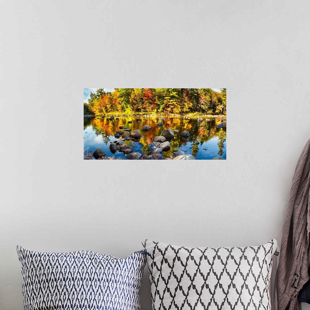 A bohemian room featuring Fine art photo of bright colors of a forest in autumn being reflected in a pond full of rocks.