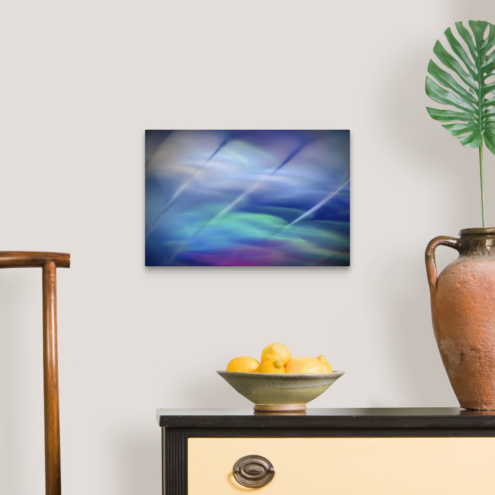 A traditional room featuring Abstract photograph in green and blue shades with streaks running across the image.