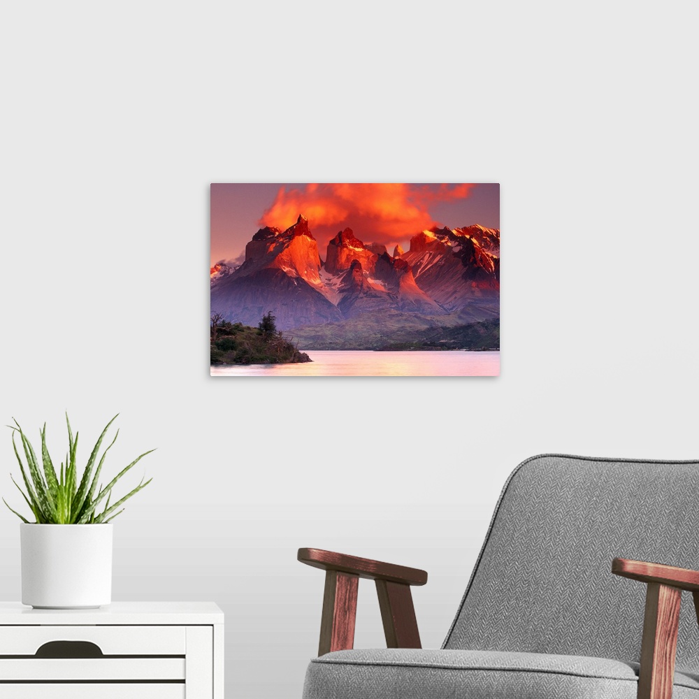 A modern room featuring This breathtaking view is of immense mountains that have warm tones at the very top from the suns...