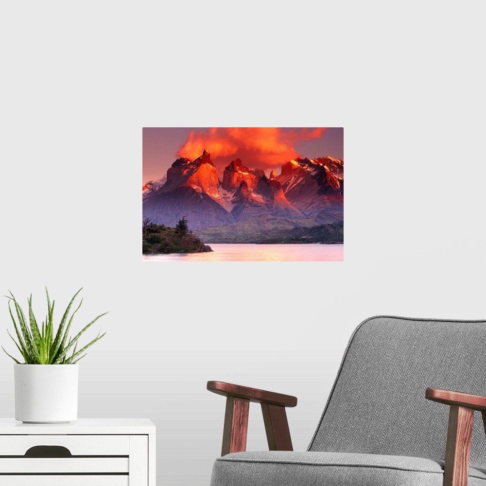 A modern room featuring This breathtaking view is of immense mountains that have warm tones at the very top from the suns...