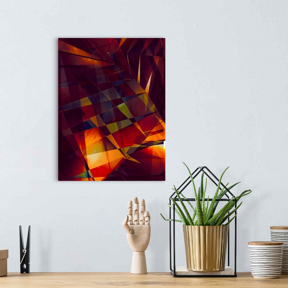 A bohemian room featuring Abstract photograph made of intersecting angles and lines in varying fiery shades.