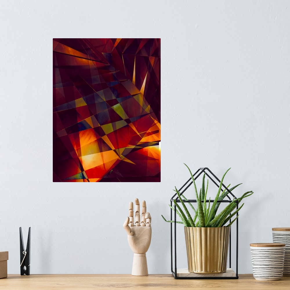 A bohemian room featuring Abstract photograph made of intersecting angles and lines in varying fiery shades.