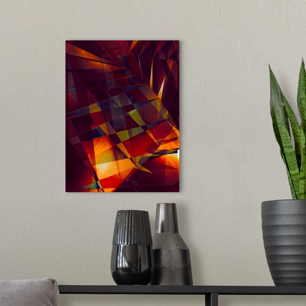 A modern room featuring Abstract photograph made of intersecting angles and lines in varying fiery shades.