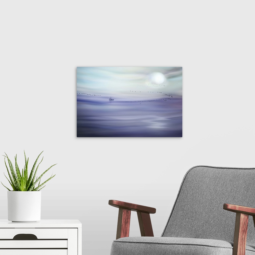 A modern room featuring An abstract photograph of a pale purple and blue landscape.