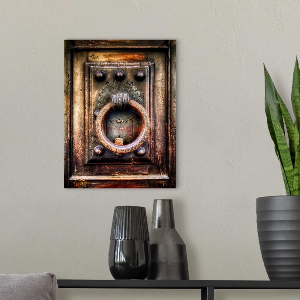 A modern room featuring Close Up View of an Antique Renaissance  Door Knocker, Florence, Tuscany, Italy.