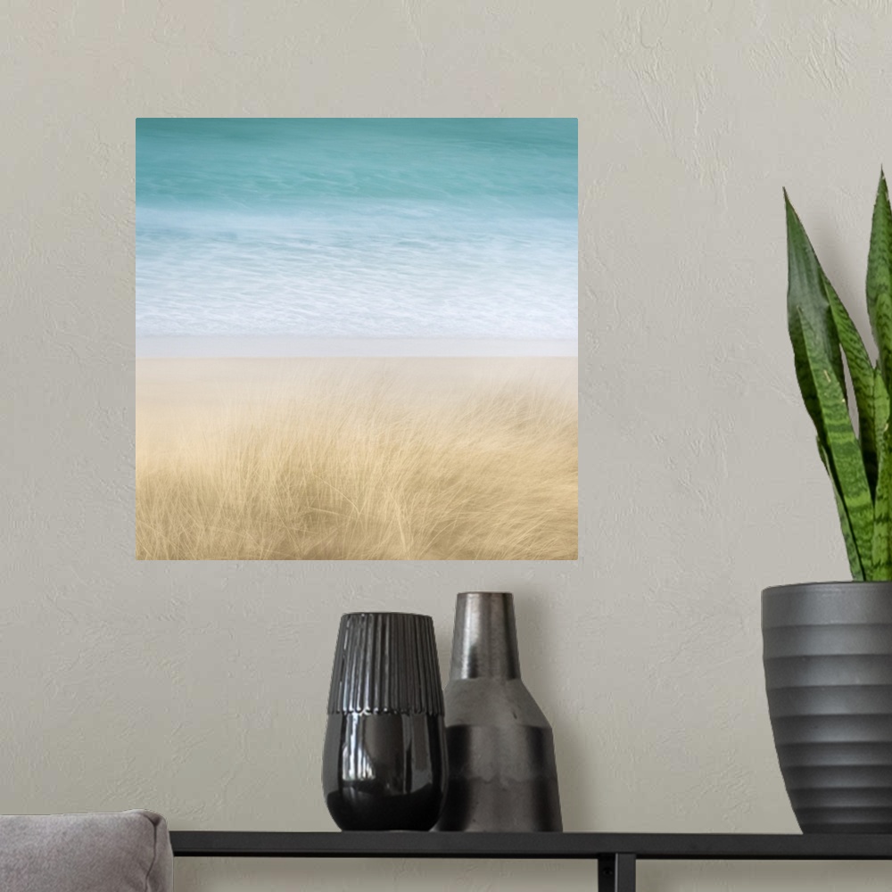 A modern room featuring Contemporary beach scene of dune grasses blowing in the wind and turquoise water blurred in the b...