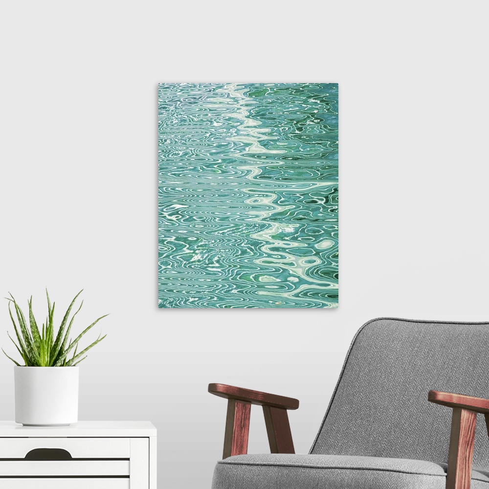 A modern room featuring Abstract pattern created by rippling water reflecting lines in a pool.