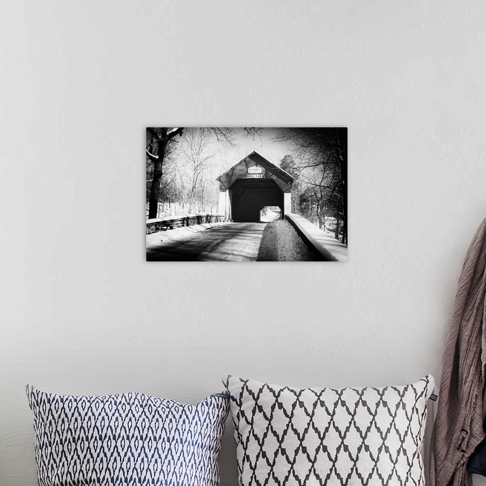 A bohemian room featuring A black and white image of Frankenfield Covered Bridge in Pennsylvania, with a light snowfall.