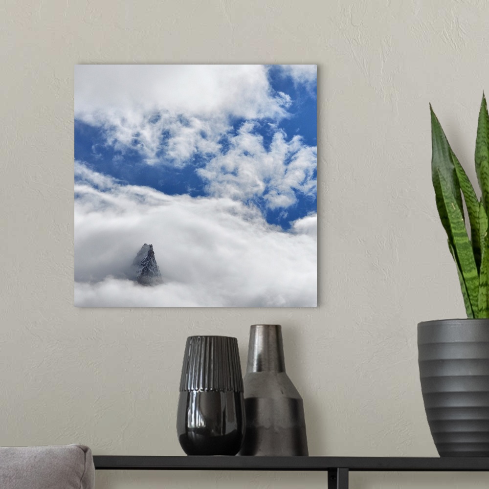 A modern room featuring French mountain, Aiguille des Dru, crossing the blue sky in the valley of Chamonix in French Alpes.