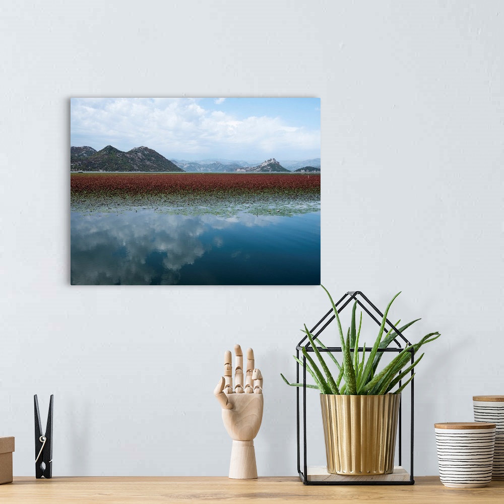 A bohemian room featuring Photograph of a beautiful landscape with mountains and a lake that is reflecting the white clouds...