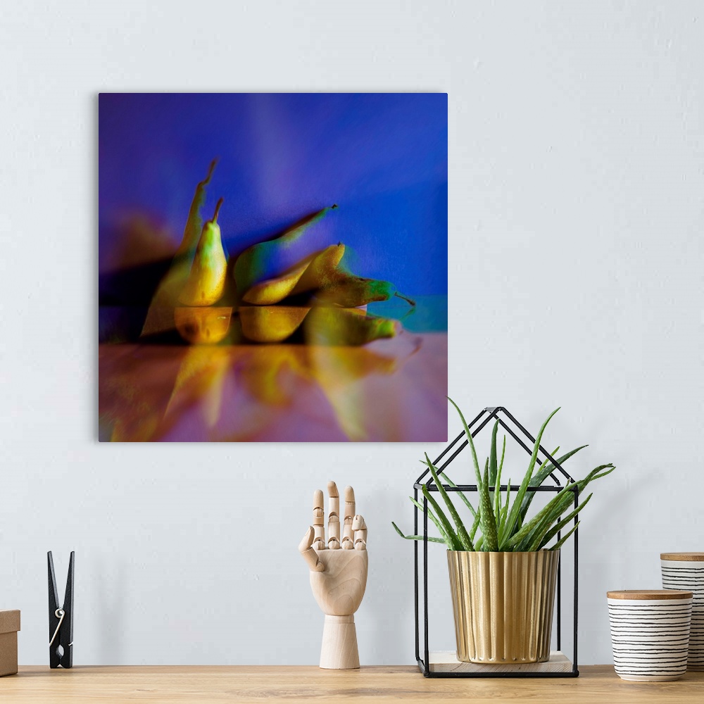 A bohemian room featuring Square photograph of pears on a blue and pink background with an abstract feel.