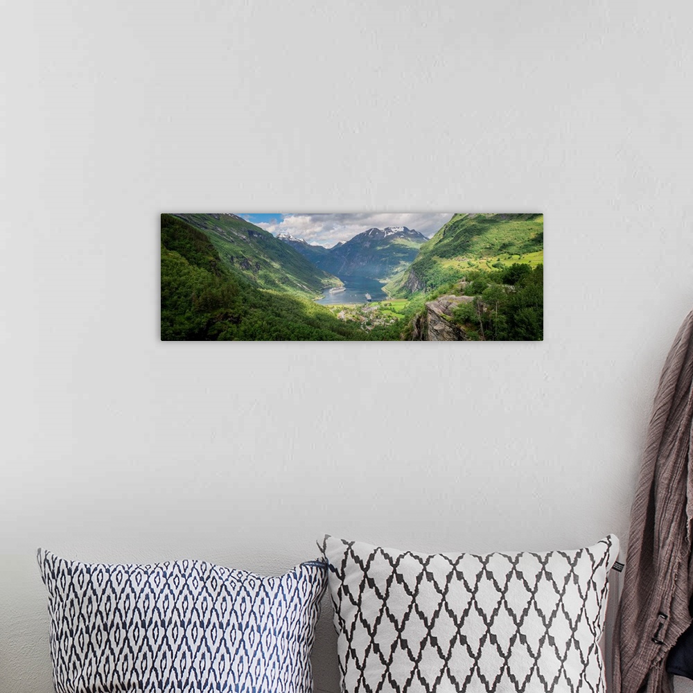 A bohemian room featuring Panoramic photograph of a stunning mountain valley scene.