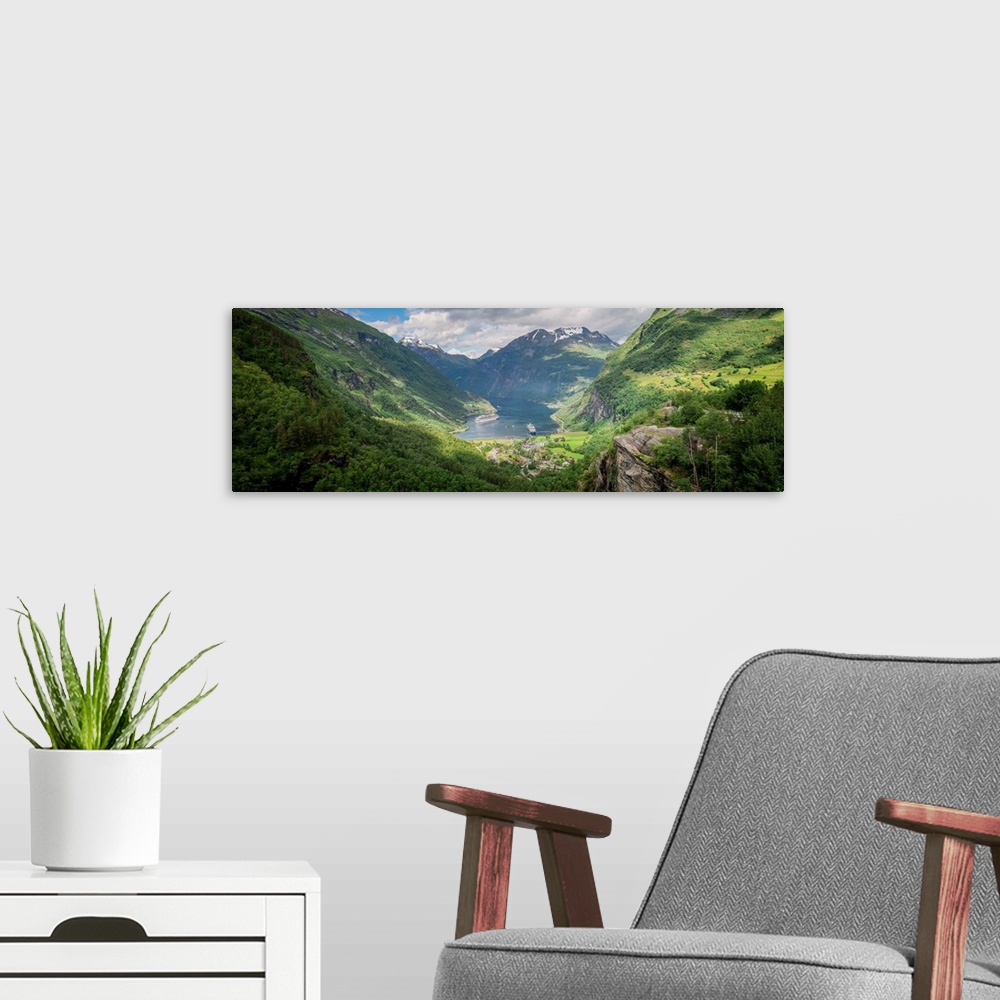A modern room featuring Panoramic photograph of a stunning mountain valley scene.
