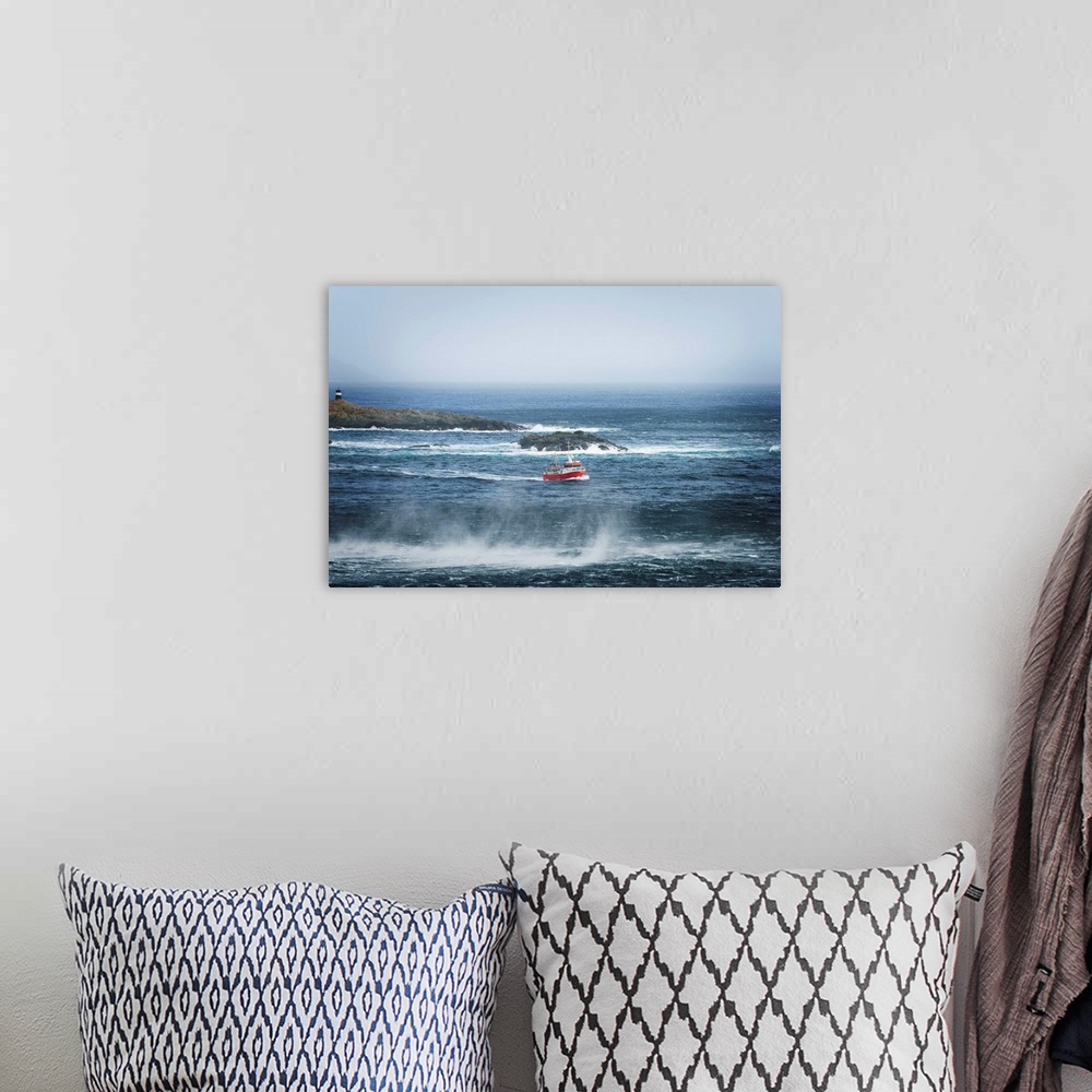 A bohemian room featuring Red fishing boat heading out to sea.