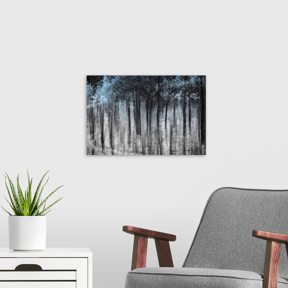 A modern room featuring This wall art is an abstract landscape photograph of dark vertical shapes contrasting with a pale...