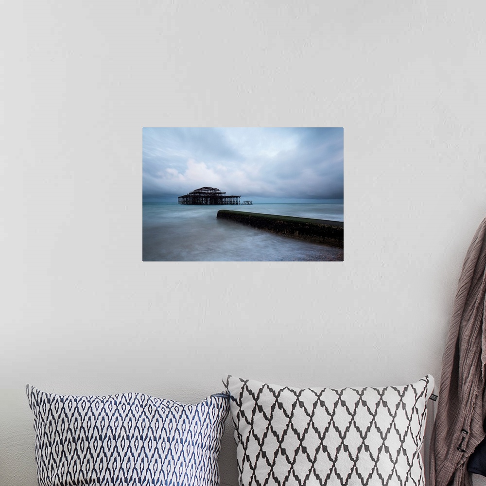 A bohemian room featuring A cool blue dramatic storm image of Brighton Pier, Sussex, UK with the Old Pier in stormy seas an...