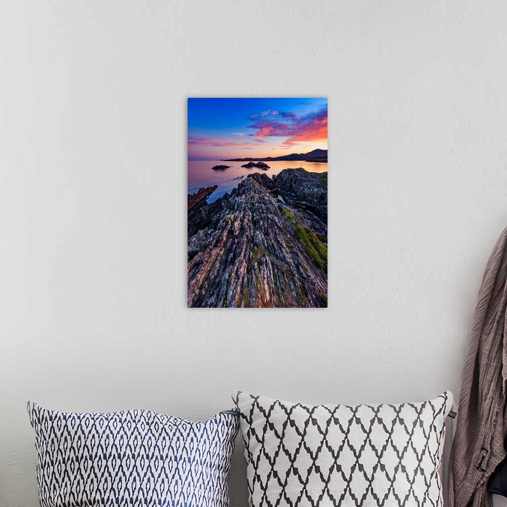 A bohemian room featuring Sunset over the sea in Ireland with rocks in the foreground