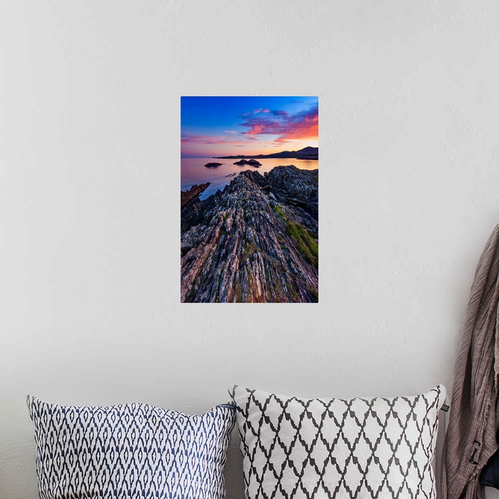 A bohemian room featuring Sunset over the sea in Ireland with rocks in the foreground