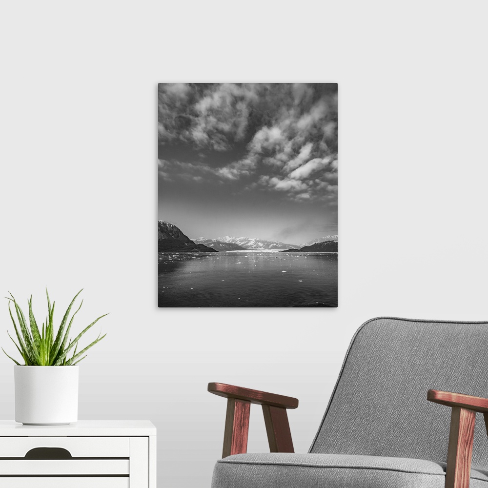 A modern room featuring Luminous black and white image of glacier mountains rising around a glacier base surrounded by ar...