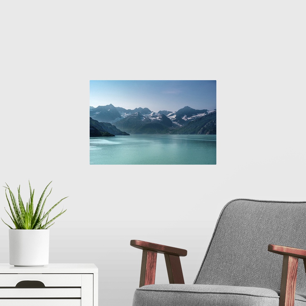 A modern room featuring Beautiful Alaskan mid-morning scene of snow capped mountains rising out of luminous aquamarine bl...