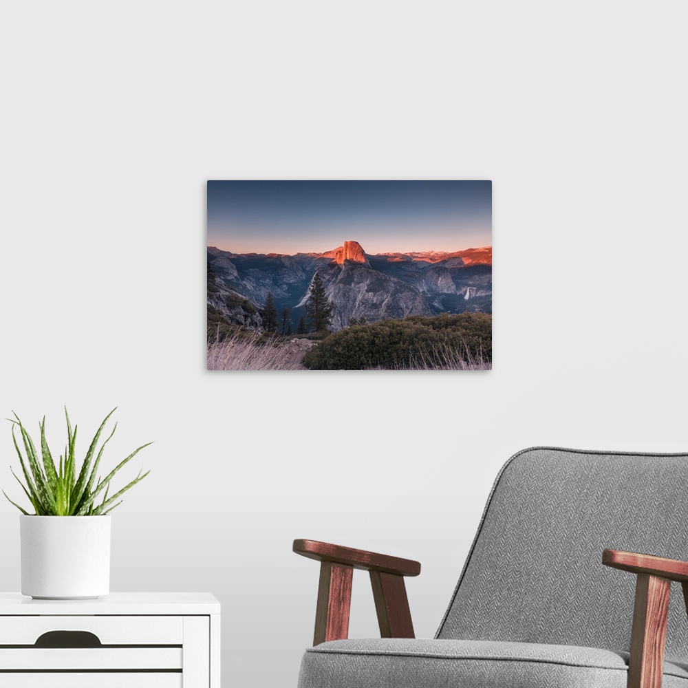 A modern room featuring Half Dome in golden color during sunset at Glacier Point, Yosemite National Park, California.