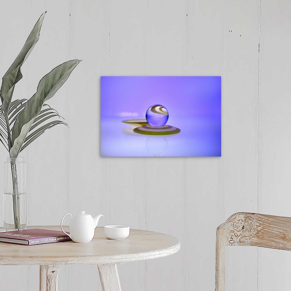 A farmhouse room featuring A macro photograph of a water droplet sitting on top purple surface against a purple background.