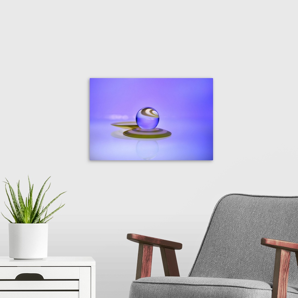 A modern room featuring A macro photograph of a water droplet sitting on top purple surface against a purple background.