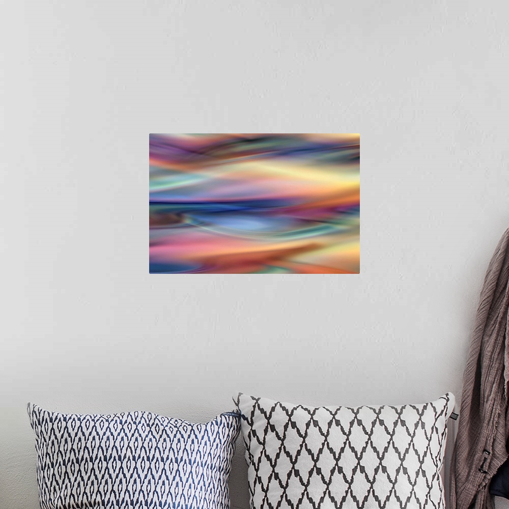 A bohemian room featuring Abstract artwork of flowing colorful tones that have been blended to create subtle ripples.