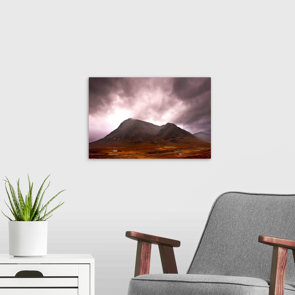 A modern room featuring A majestic Scottish mountain in Glencoe with dramatic storm clouds and rich autumn colours with a...