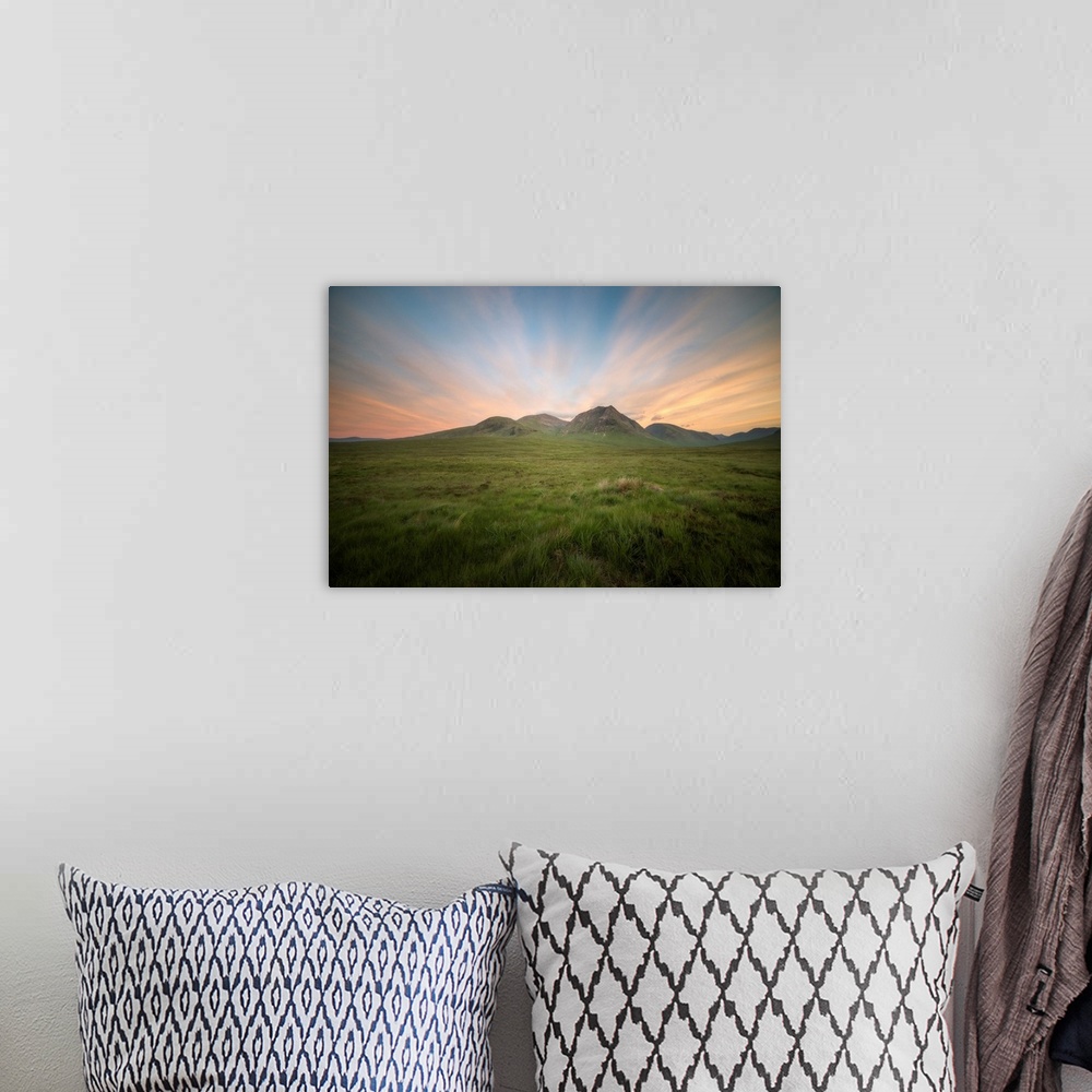 A bohemian room featuring Glencoe valley at sunset next to etive mor in scotland, a green valley with mountains on background.