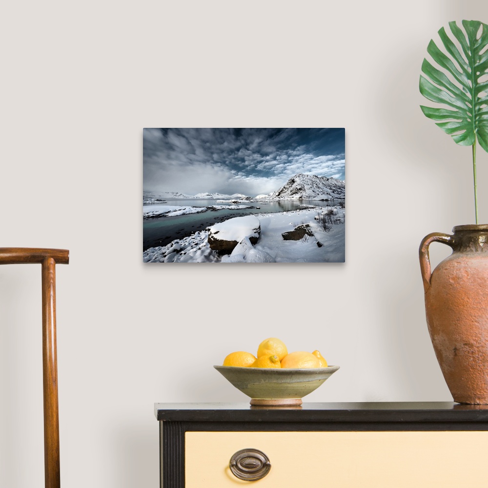 A traditional room featuring A photograph of a rugged winter landscape under a sky of dark clouds.