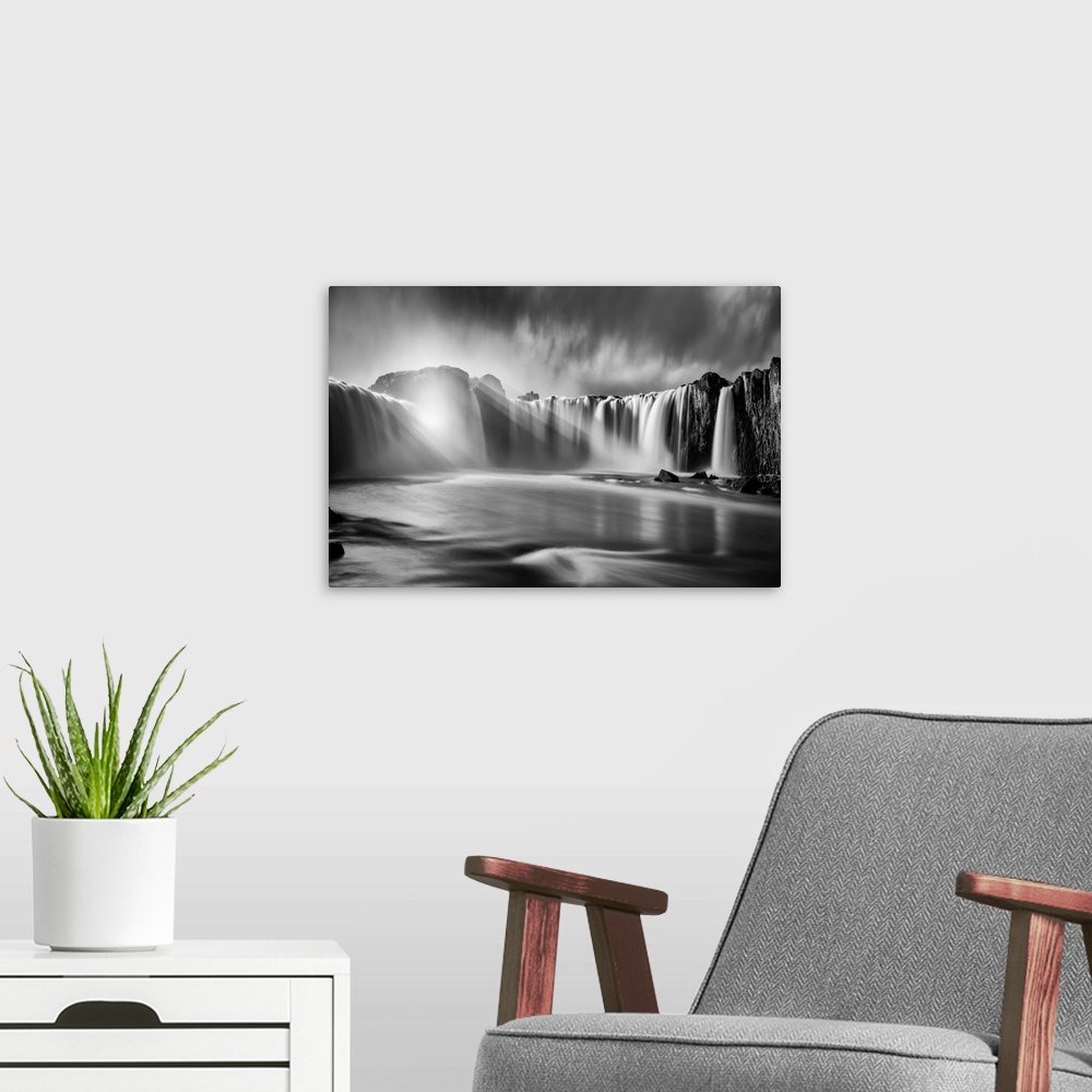 A modern room featuring Fine art photograph of sunlight shining over the waterfalls in Iceland.