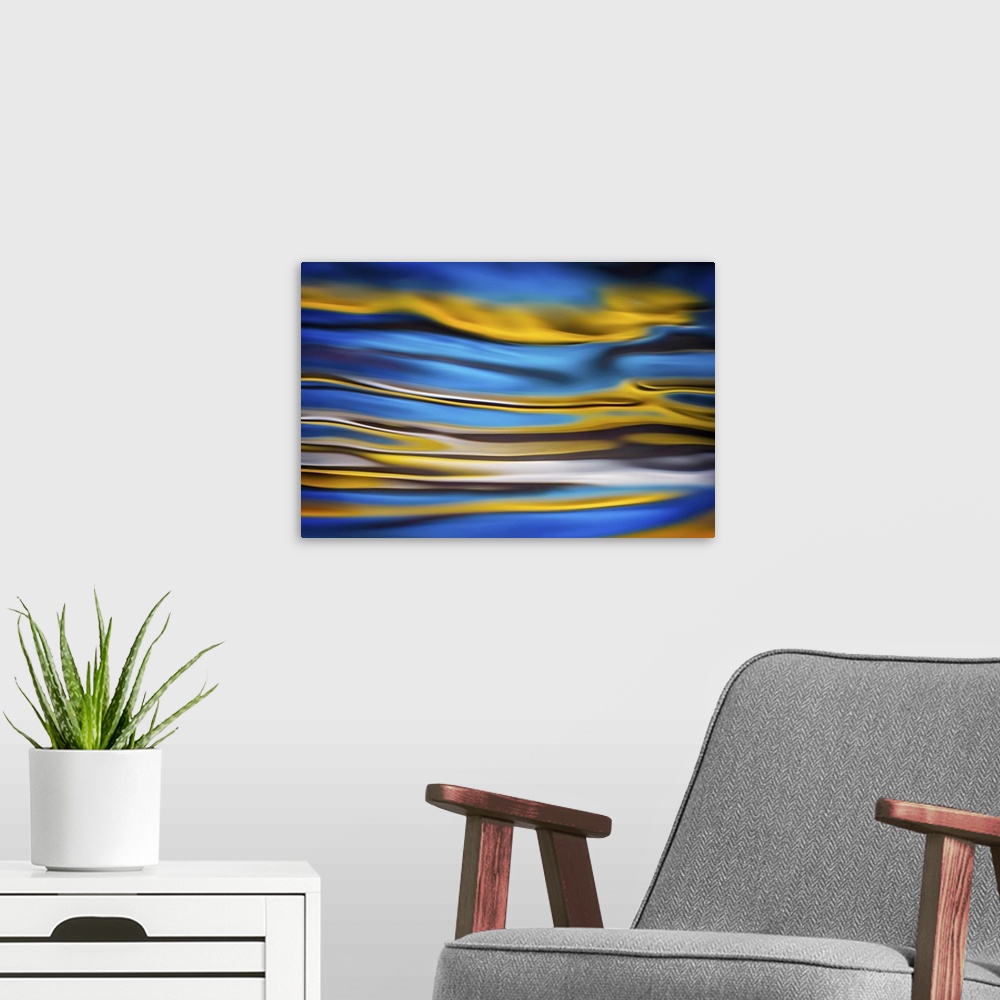 A modern room featuring Abstract landscape in gold and blue.