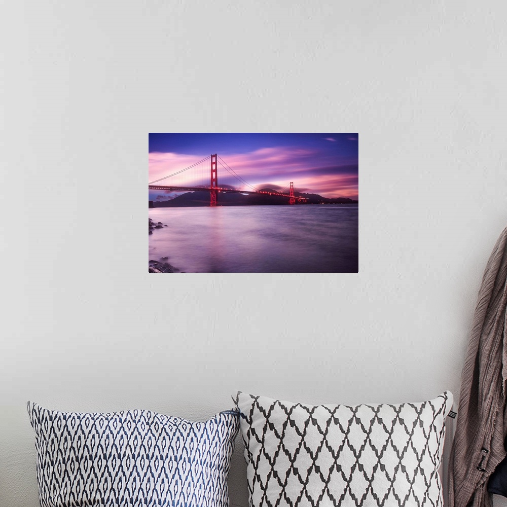 A bohemian room featuring Landscape photograph of a purple and pink sunset over the Golden Gate Bridge in San Francisco wit...