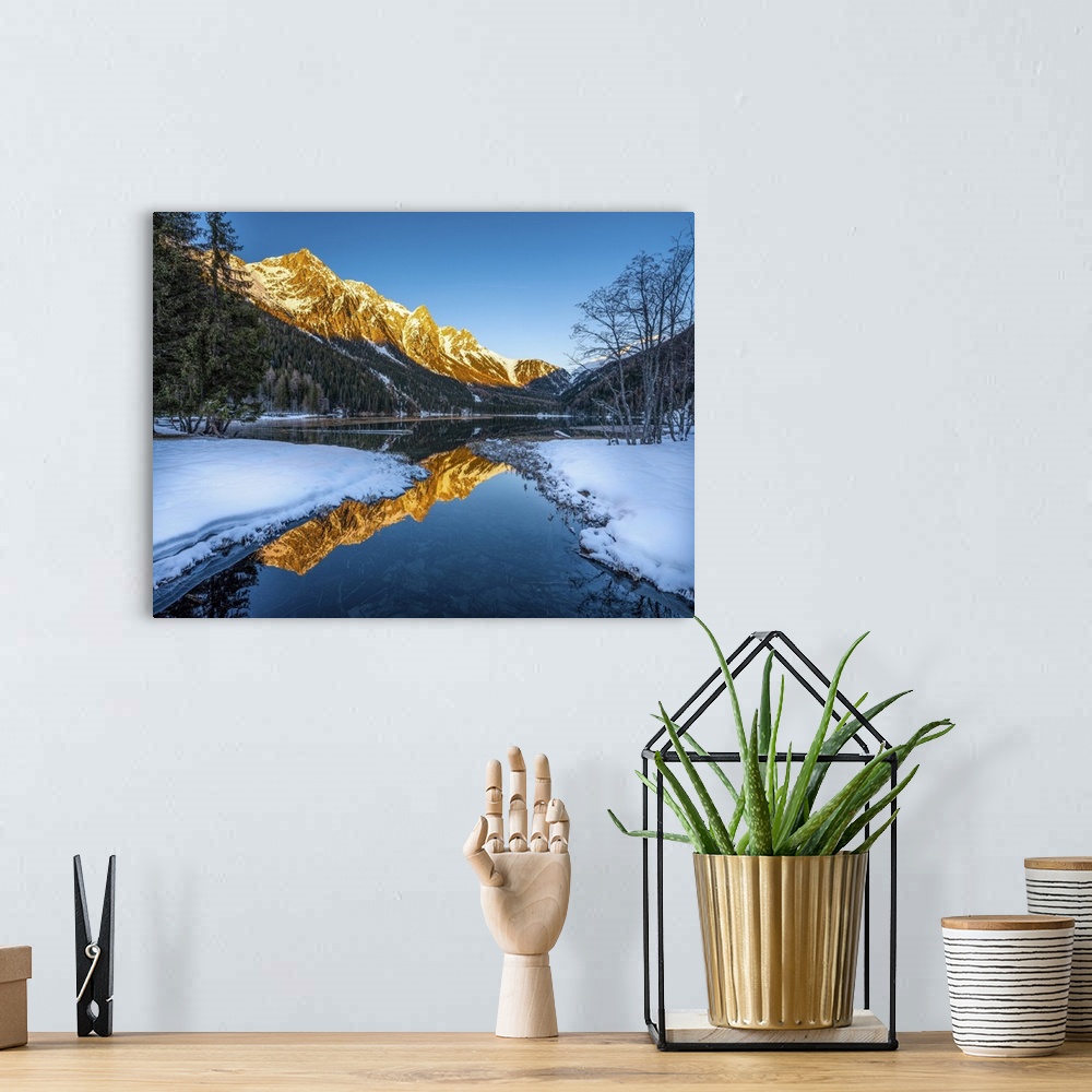 A bohemian room featuring An alpine landscape in the middle of Lake Anterselva after a heavy snowfall. The sunset with its ...