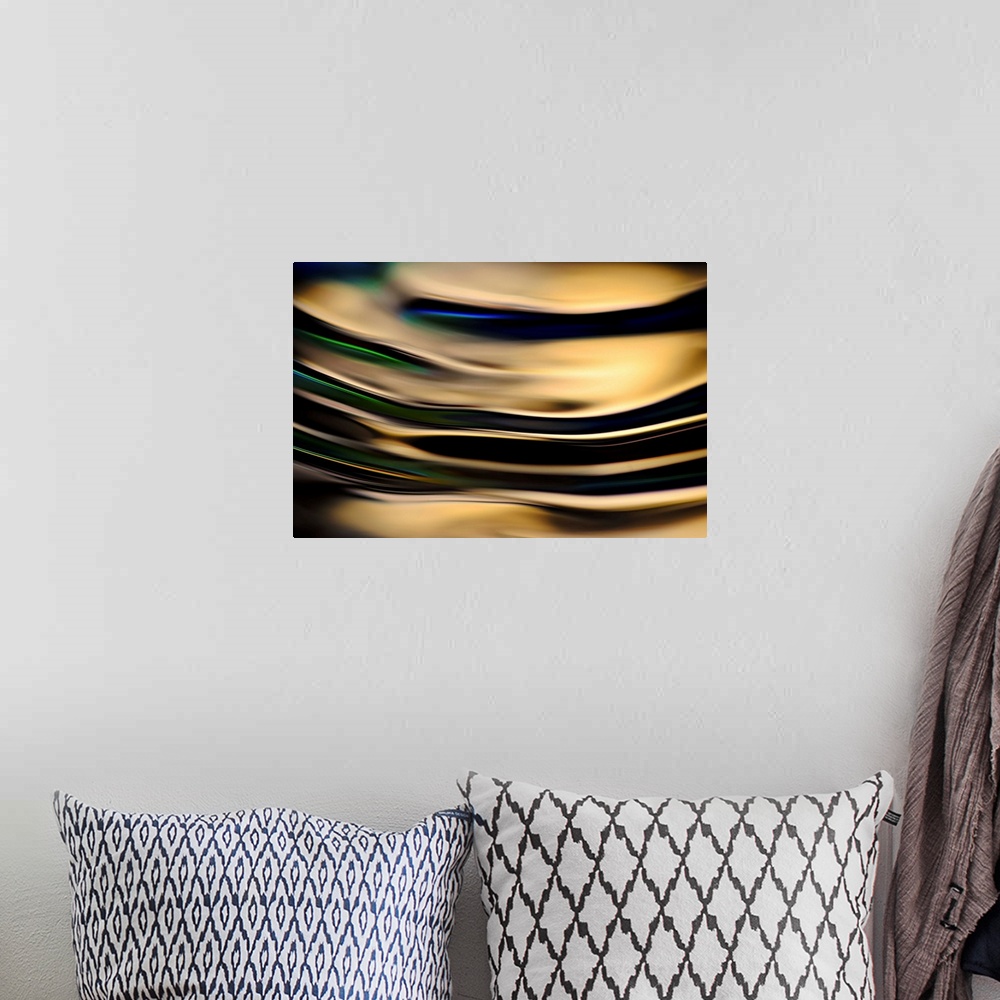 A bohemian room featuring Abstract photograph of rippling water up close with gold reflections and hints of blue, green, an...