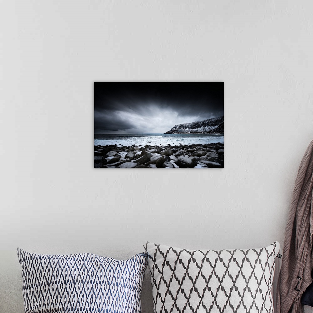 A bohemian room featuring A photograph of a rugged winter landscape under a sky of dark clouds.