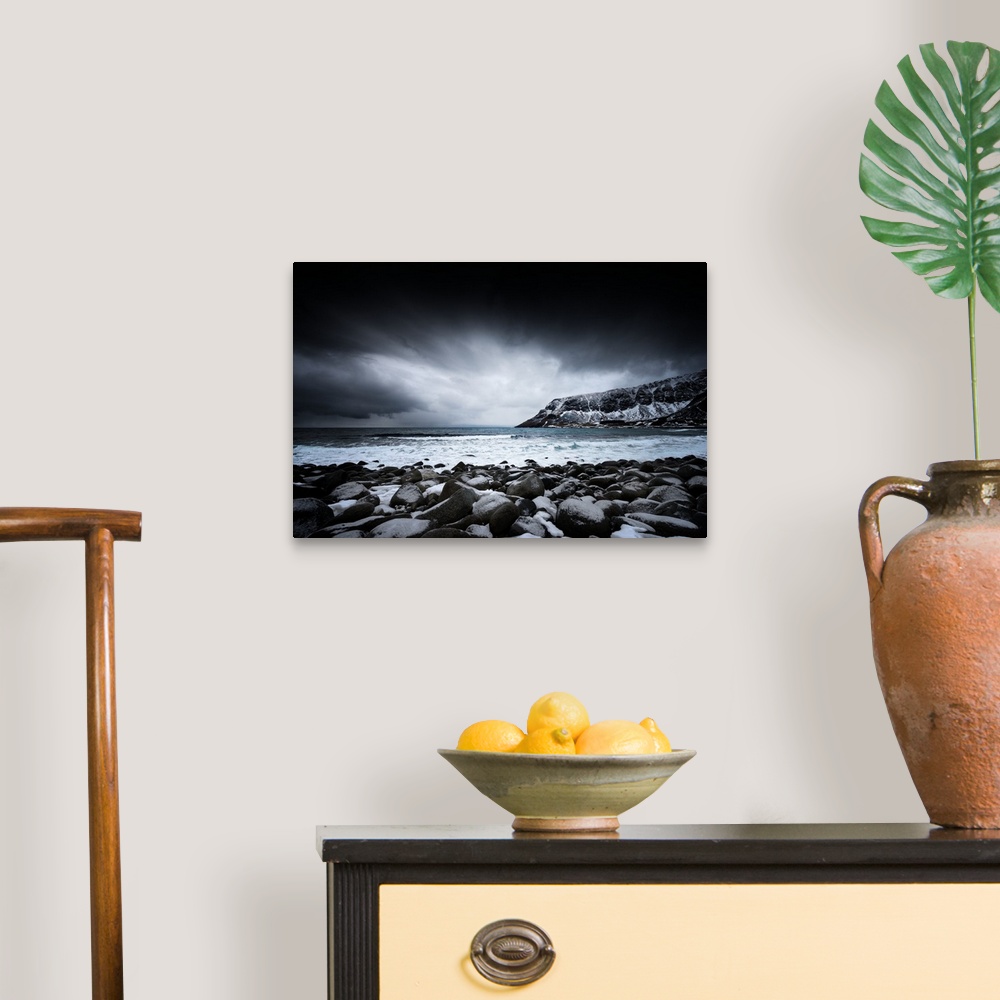 A traditional room featuring A photograph of a rugged winter landscape under a sky of dark clouds.