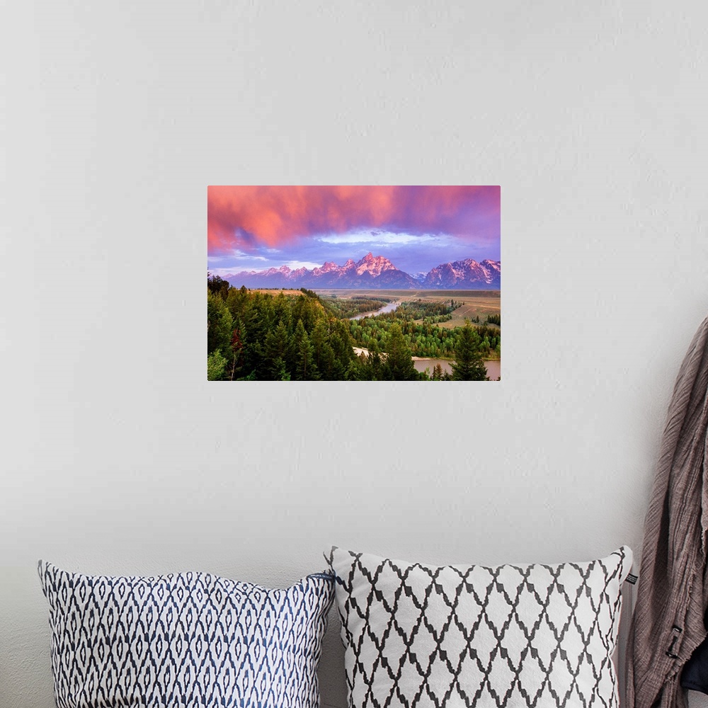 A bohemian room featuring Giant landscape photograph of a vast pine forest in front of the Grand Tetons, beneath a sky of v...