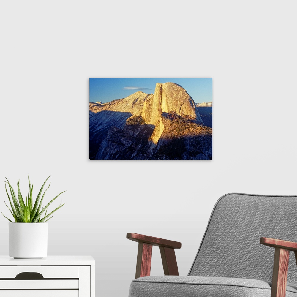 A modern room featuring Alpine Glow on Half Dome, Yosemite National Park, California. The morning sun lights up the peak ...