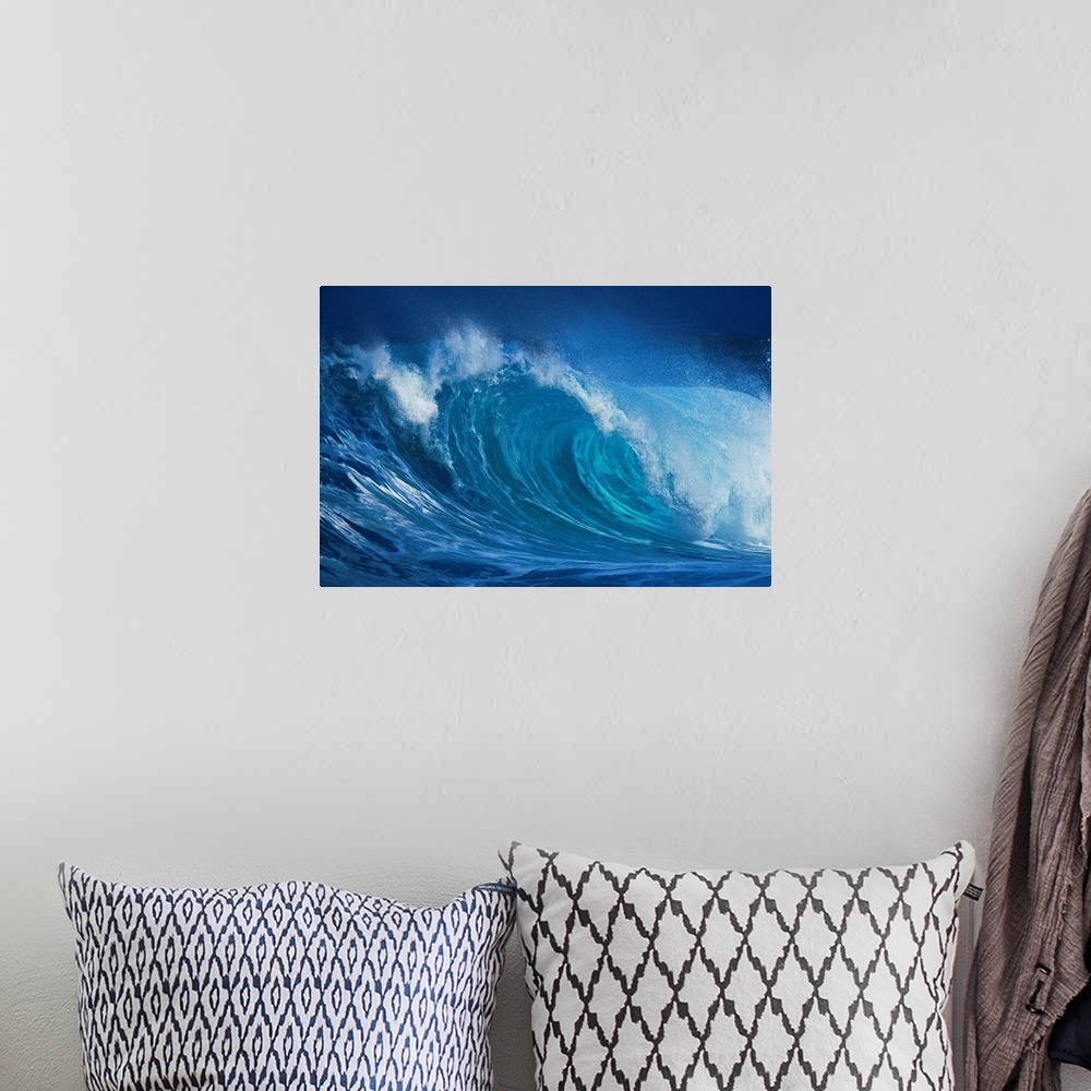 A bohemian room featuring A close up horizontal photograph of a curling wave. During late November through mid-January, the...