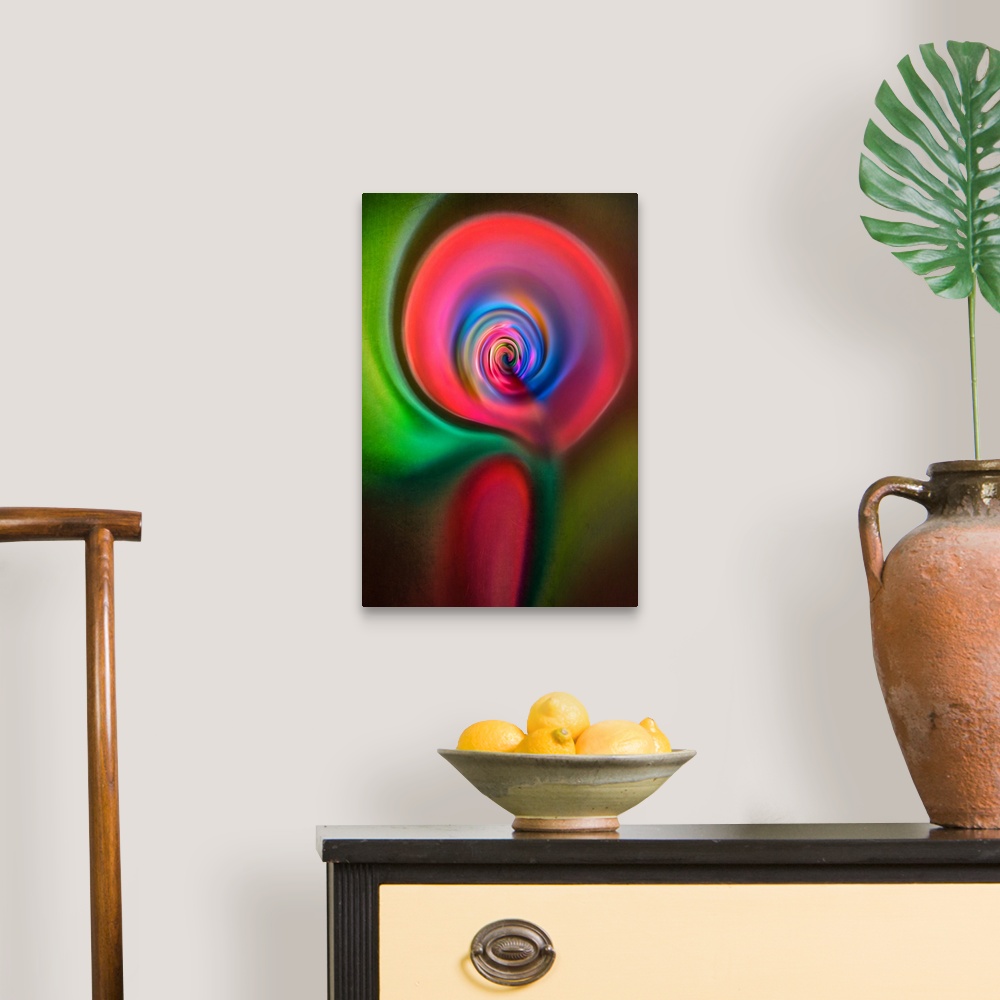 A traditional room featuring Abstract photograph in green and red swirling shapes, resembling a candle.