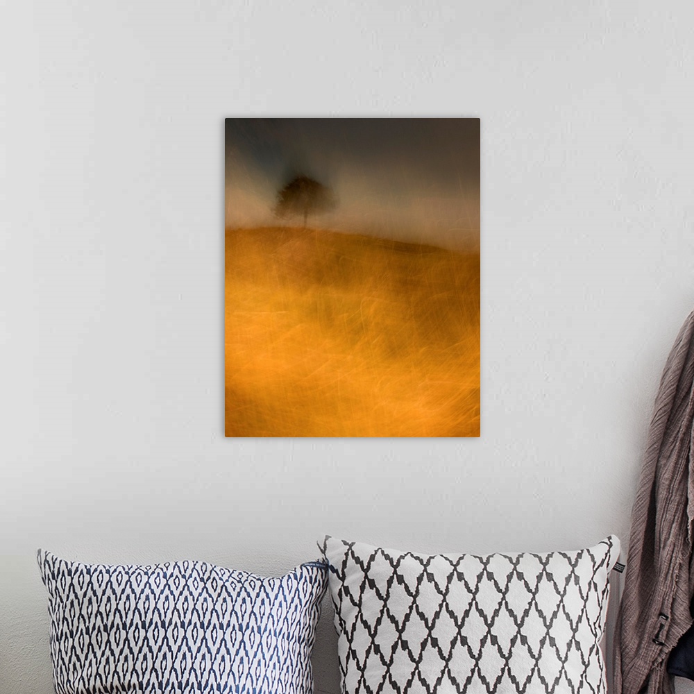 A bohemian room featuring An impressionistic image of a lone tree in a storm on a small hill in a field of golden grasses.